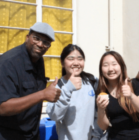 Valley charter middle school student orientation: a teacher with a couple of students getting ready for the year with a thumbs up!