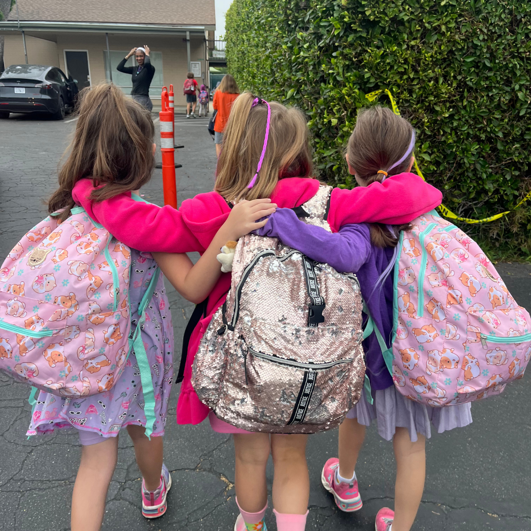 Friends walking into Valley Charter Elementary School on the last day of the 2024-25 school year.